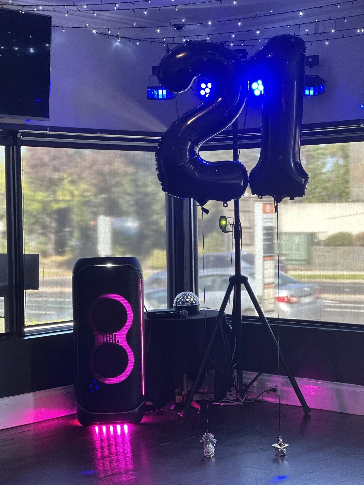 PartyBox speaker and blue lighting at an event