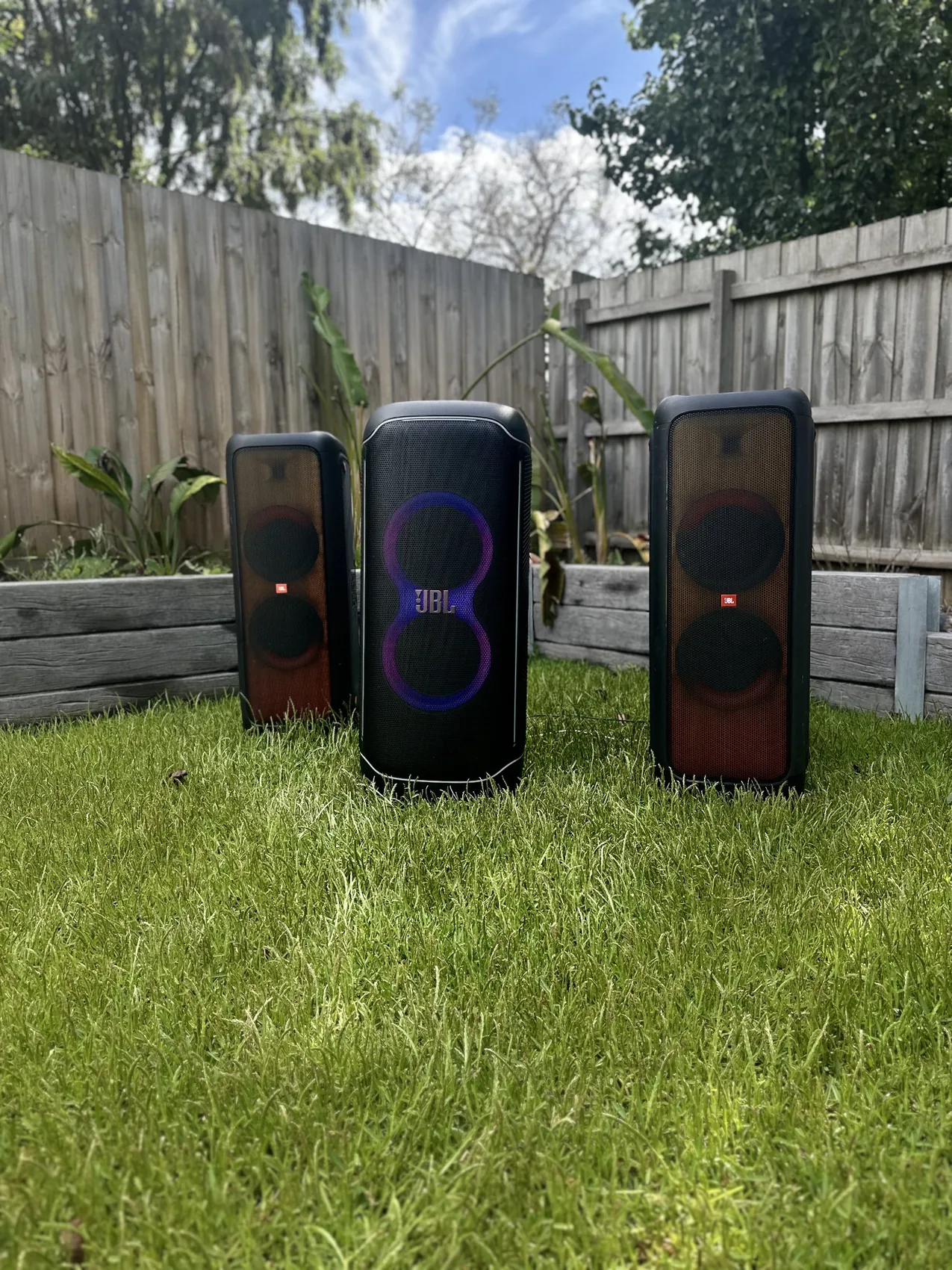 Three JBL PartyBox speakers outdoors